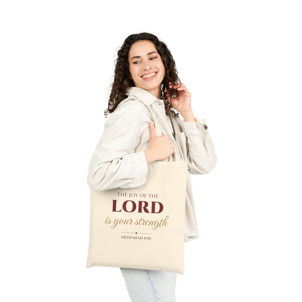 Woman carrying Joy of the Lord Nehemiah 8:10 tote bag